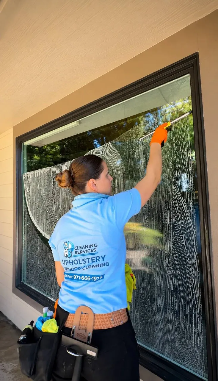 AB Cleaning Services NW owner cleaning a window in the Portland area